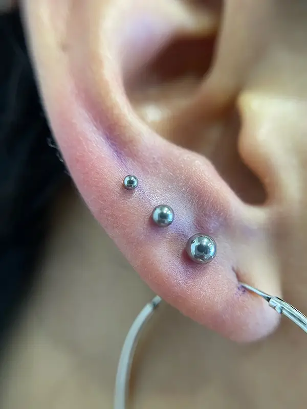 Triple perforación de lóbulo en línea perfecta con joyería básica grado implante - Laura Blu